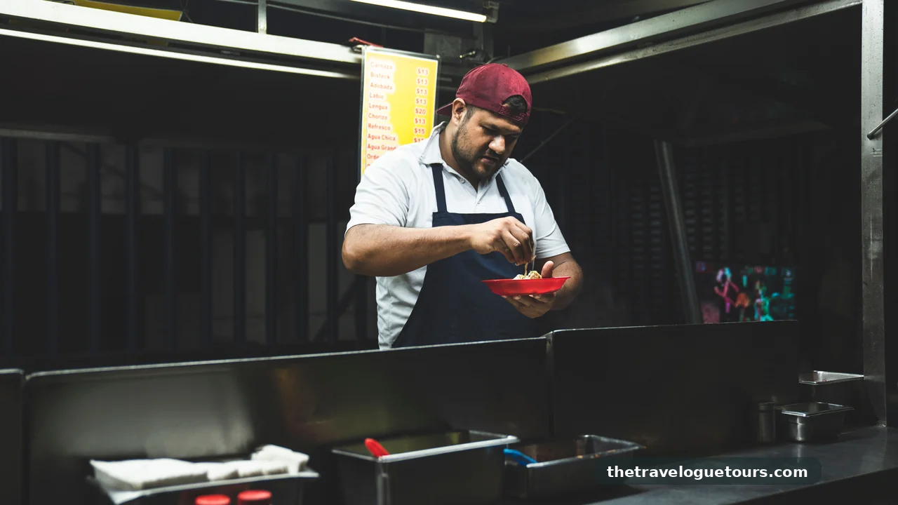 A taco vendor preparing fresh tacos at a nighttime street food stand in Mexico City