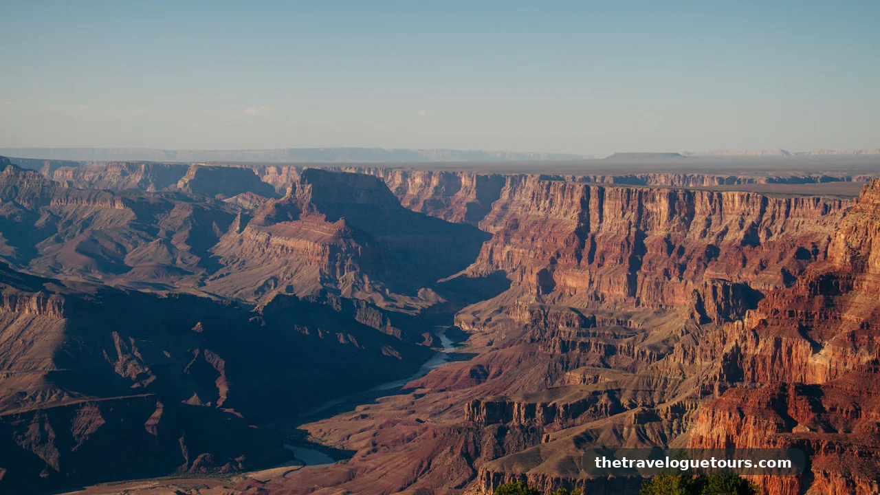 Aerial view of the Grand Canyon at sunset showcasing layered rock formations