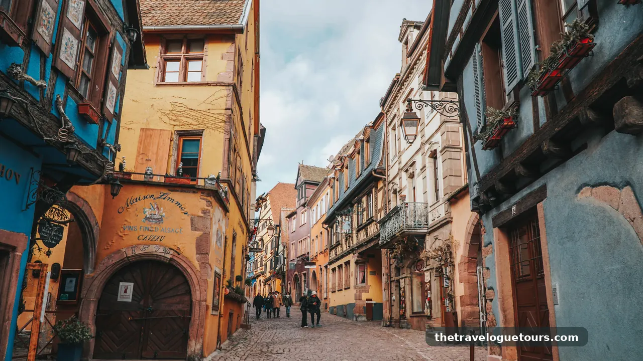 Vibrant cobblestone street in Colmar, France, showcasing colorful historic buildings
