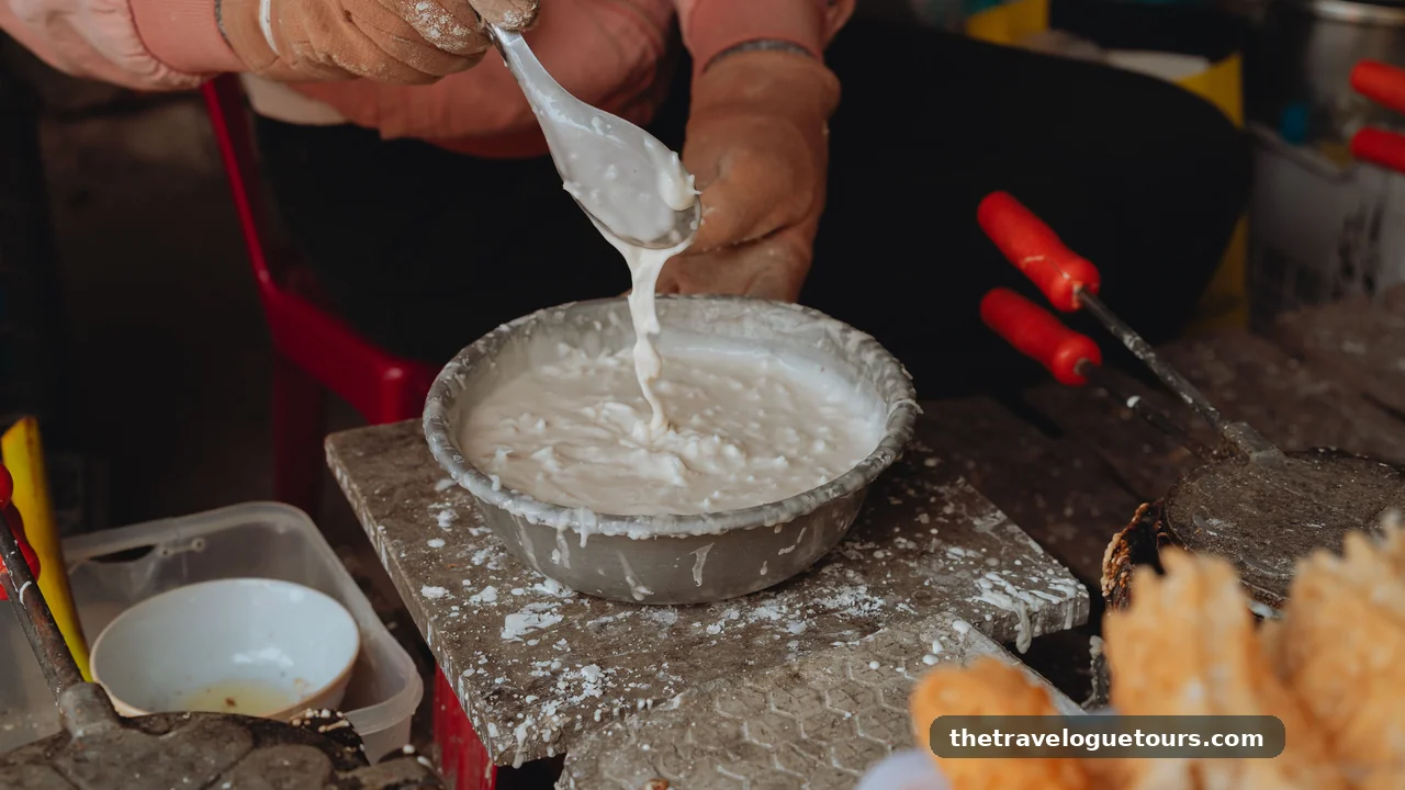 Close-up of a Vietnamese street vendor making traditional waffles