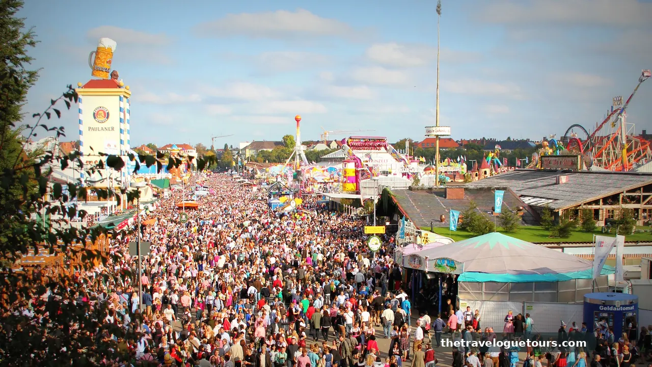 Aerial view of the Oktoberfest fairgrounds in Munich with crowds, rides, and beer tents