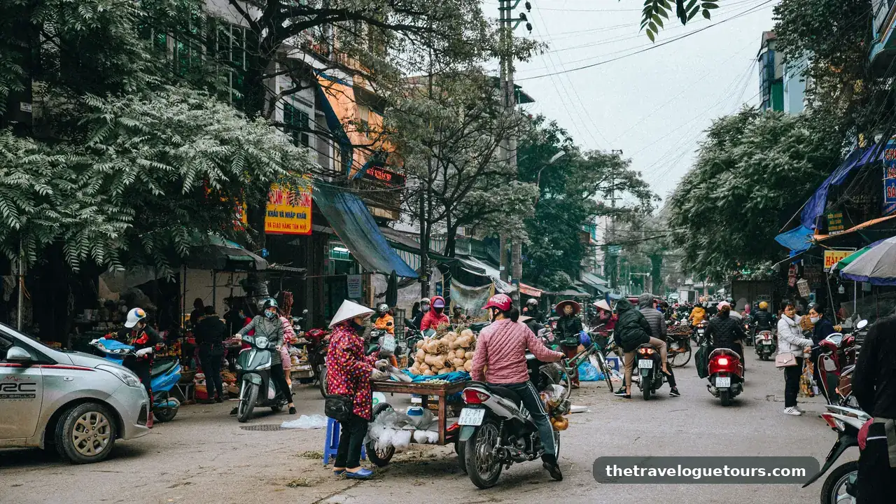 A bustling street market in Lang Son, Vietnam with motor scooters and vendors