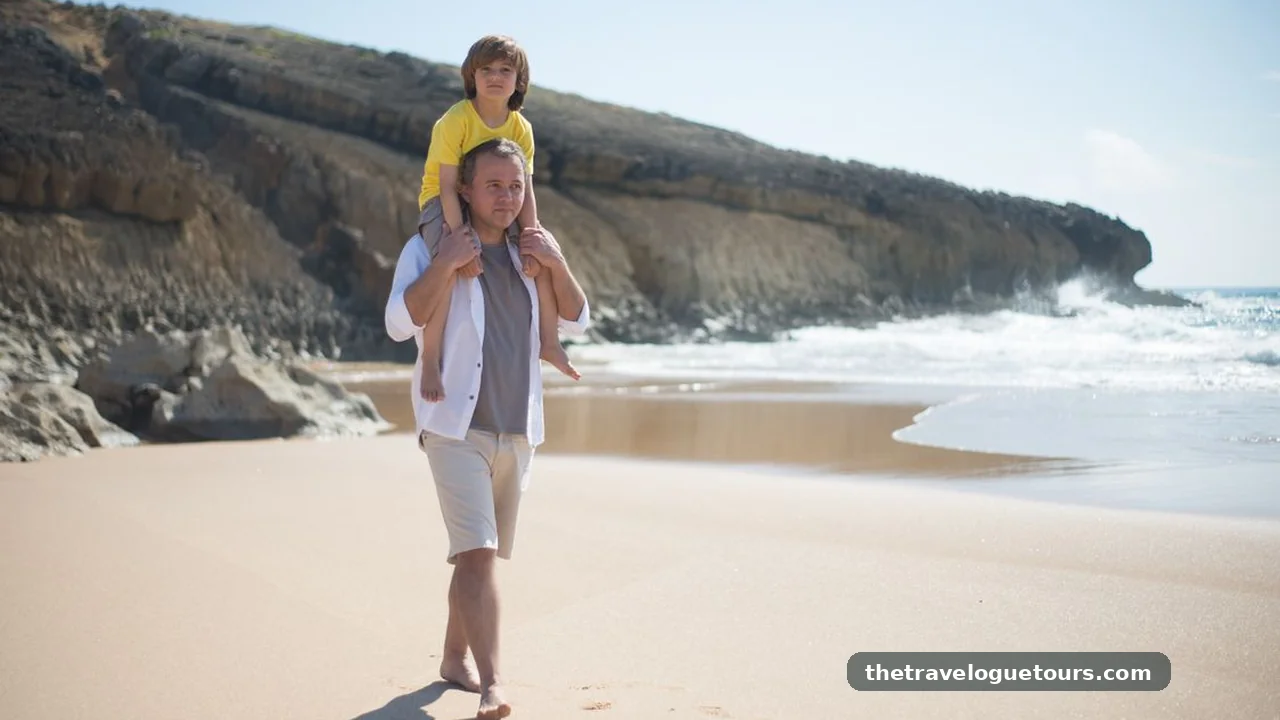Father carrying his young son on his shoulders while walking on a sunny beach
