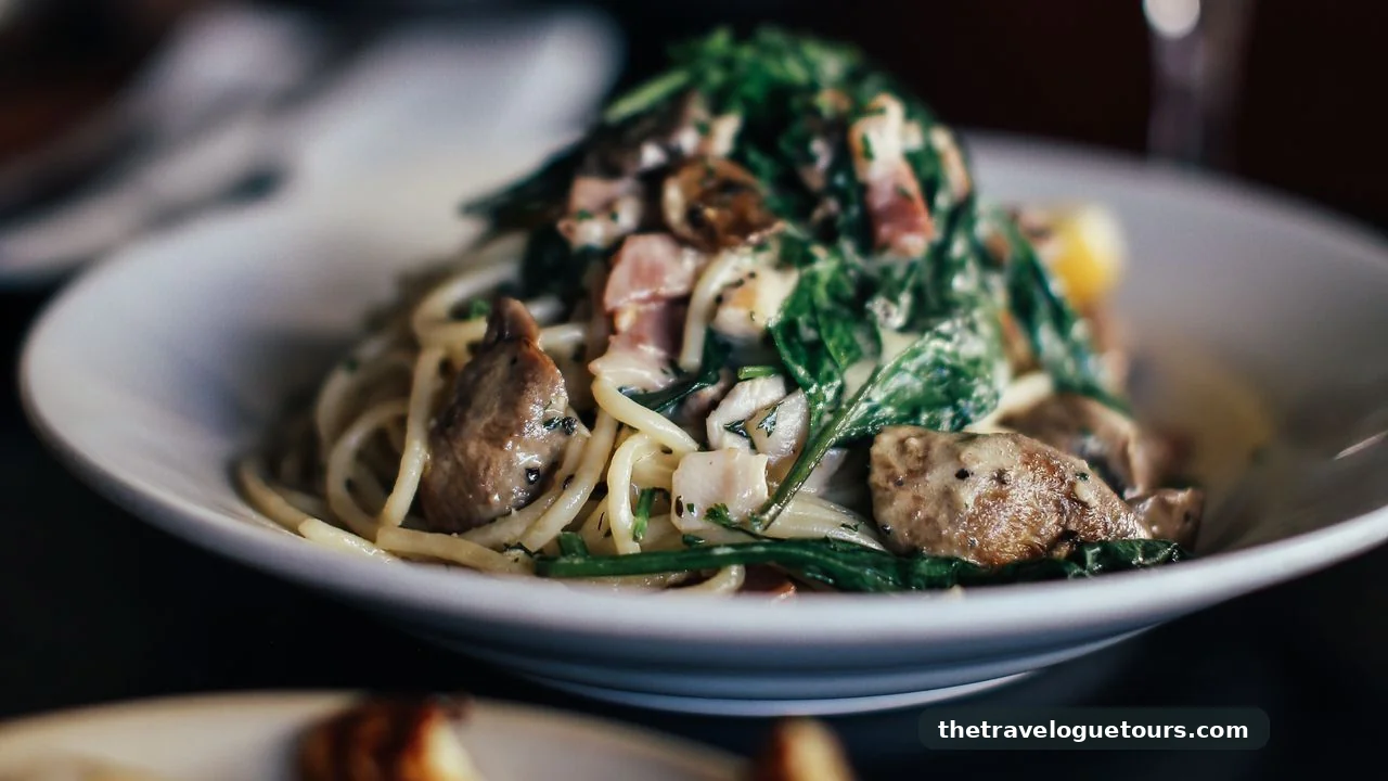 Spaghetti with mushrooms and fresh greens served at an Italian restaurant table