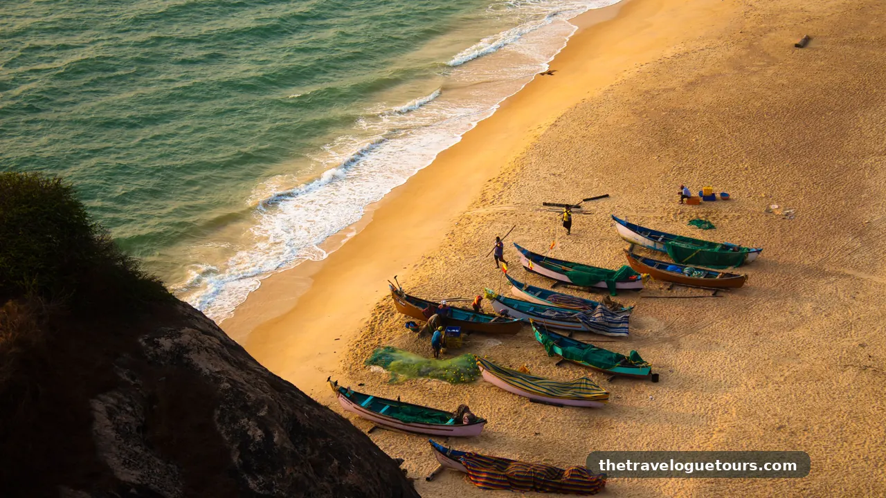 Aerial view of colorful fishing boats pulled up on a golden beach at Kaup Beach, Karnataka