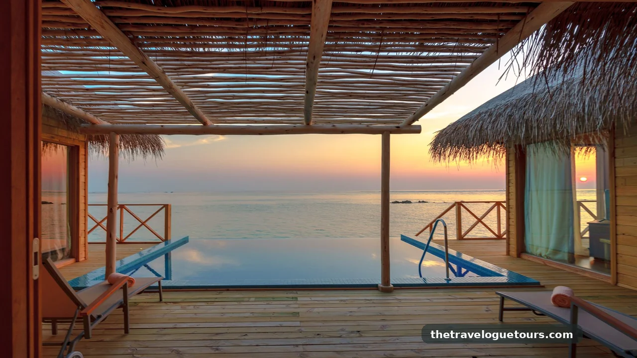 Luxury overwater villa with private pool at sunset in the Maldives